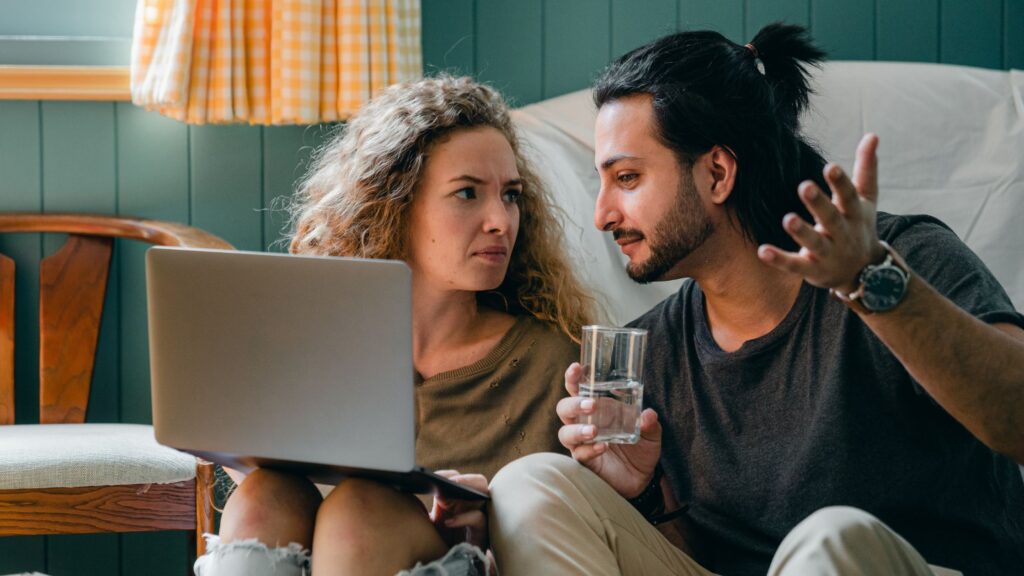 Image of a couple concerned about a result on their laptop. Parenting test header image.